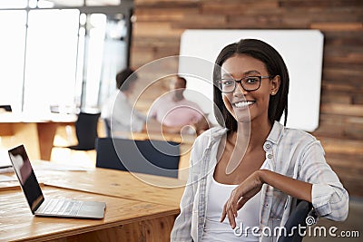 Portrait of young black woman in creative office Stock Photo