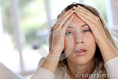 Portrait of young blond woman getting bored Stock Photo