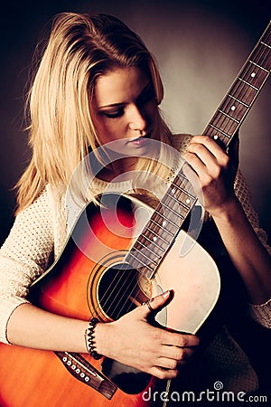 Portrait of young blonde guitar player woman Stock Photo