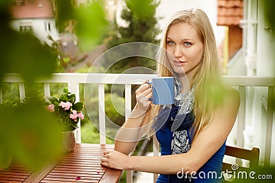 Portrait of young blonde woman drinking tea Stock Photo