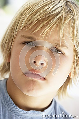 Portrait Of Young Boy Frowning Stock Photo