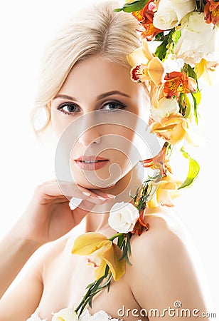 Portrait of a young bride in a white dress posing with flowers Stock Photo