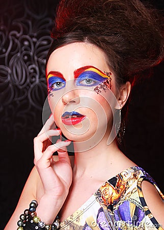 Portrait of young brunette woman with artistic make-up, close up. Beauty concept. Stock Photo