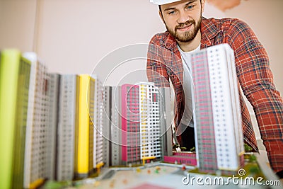 Portrait of young builder dealing with complex construction model Stock Photo