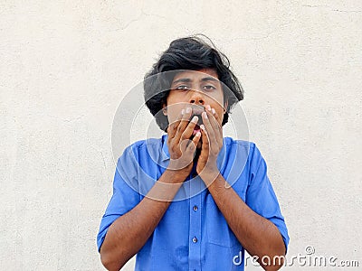man covering his mouth with two hands.Heard exciting incredible news, cant believe, white background Stock Photo