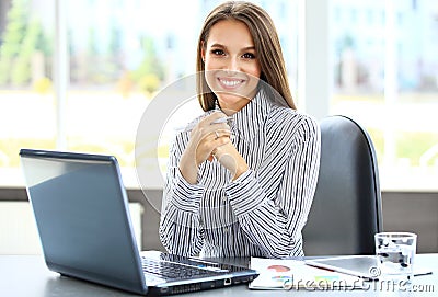 Portrait of a young business woman using laptop Stock Photo