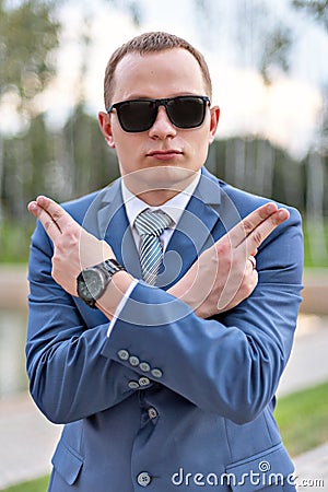 Portrait of a young businessman joking shows pistols with fingers Stock Photo