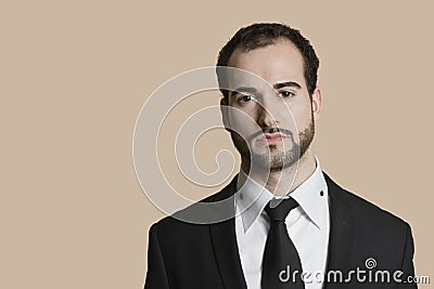 Portrait of young businessman with short hair and beard over colored background Stock Photo