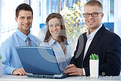 Portrait of young businessteam with laptop Stock Photo