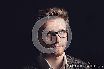 Portrait of young casual man with glasses smiling in front of camera. Young handsome man in navy shirt and glasses Stock Photo