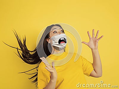 Portrait of young caucasian woman with emotion on her protective face mask Stock Photo