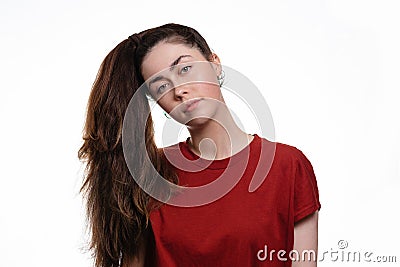 Portrait of a young caucasian woman with a ponytail hanging over her head. White background. The concept of unruly hair and its Stock Photo