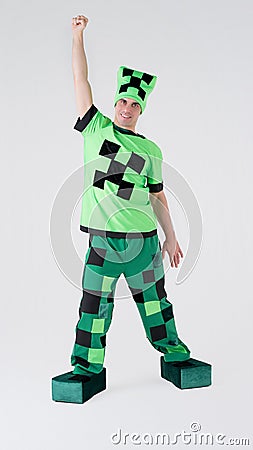 Portrait of a young cheerful man in a beautiful green suit with black patterns of squares on a white background. Animator in Stock Photo
