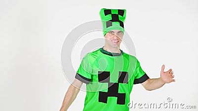 Portrait of a young cheerful man in a beautiful green suit with black patterns of squares on a white background. Animator in Stock Photo