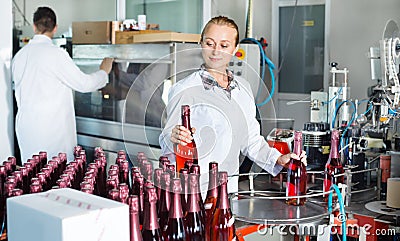 Woman working on wine production on manufactory Stock Photo