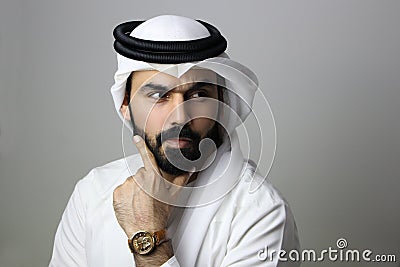 Portrait Of A Young Confident Arab Businessman Wearing UAE Emirati Tradational Dress Stock Photo