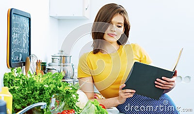 Portrait of young cooking woman in kitchen. Stock Photo