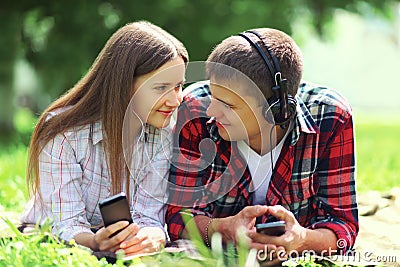 Portrait of young couple lying relaxing on the grass together Stock Photo