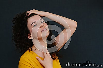 Portrait of young cute emotional caucasian female on grey background. Stock Photo
