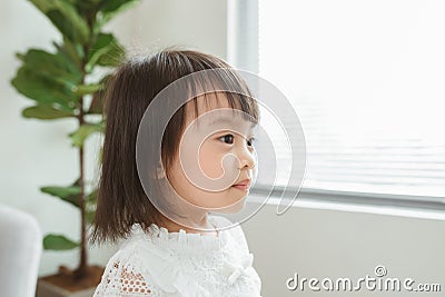 Portrait of young cute girl in living room Stock Photo