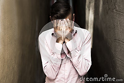 Portrait of young, depressed man in pain Stock Photo