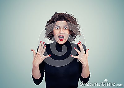 Portrait of a young emotional woman in a black turtleneck with an expression of deep horror and fear on her face Stock Photo
