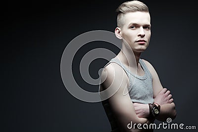 Portrait of young fashionable man in trendy sleeveless shirt Stock Photo