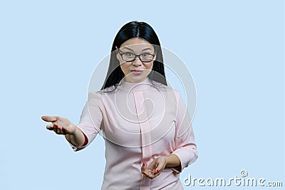 Portrait of a young female asian boss in glasses is giving you an order. Stock Photo