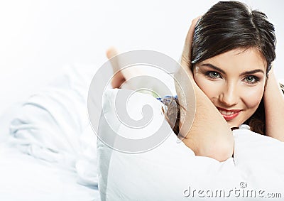 Portrait of young female model lying in bed. Stock Photo