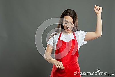 Portrait of young female supermarket employee holding full pockets Stock Photo