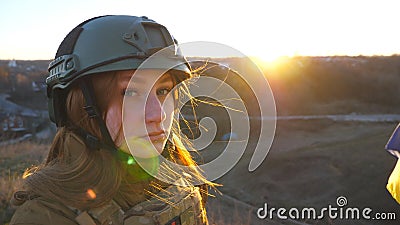 Portrait of young female ukrainian army soldier. Sad emotion on face of girl in military helmet during war in Ukraine Stock Photo
