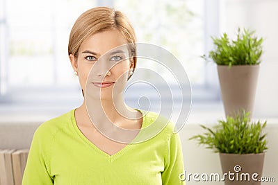 Portrait of young female in vivid green smiling Stock Photo