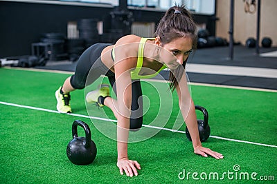 Portrait of young fit woman doing abs and legs fitness exercises in gym Stock Photo