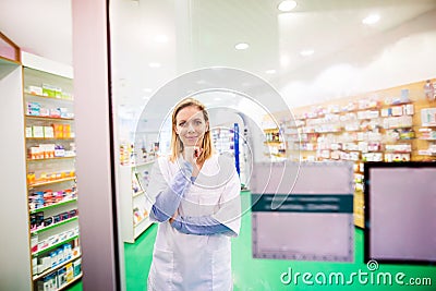 Portrait of a young friendly female pharmacist. Stock Photo