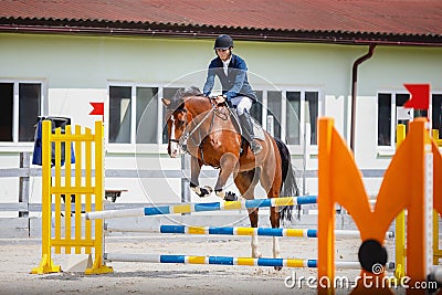 Young gelding horse and adult man rider knocked jump pole during equestrian show jumping competition Stock Photo