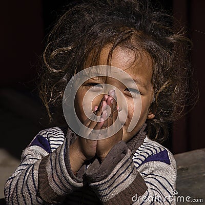 Portrait young girl with folded hands in street, Nepal. Close up Editorial Stock Photo