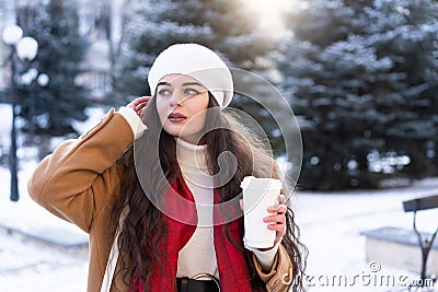 portrait of a young girl with hot fragrant coffee in her hands bending her on a cold day Stock Photo