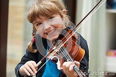 Portrait Of Young Girl Learning To Play Violin Stock Photo