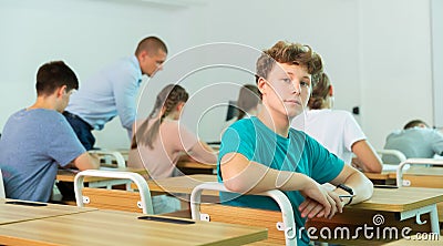 Portrait of young guy student in audience, looking at camera Stock Photo