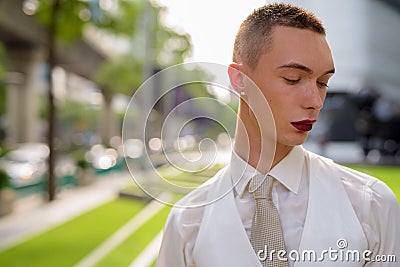 Young androgynous homosexual LGTB businessman wearing lipstick Stock Photo