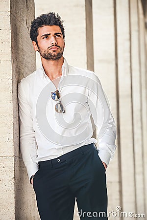 Portrait of young handsome man in white shirt outdoor. Stock Photo