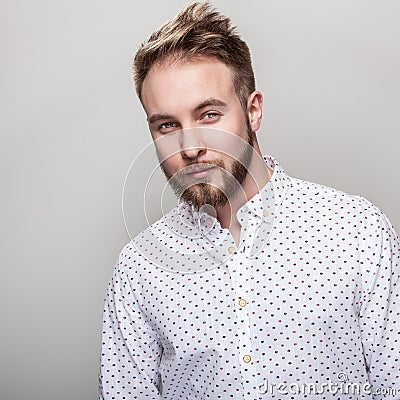 Portrait of young handsome positive man in white shirt with an amusing pattern Stock Photo