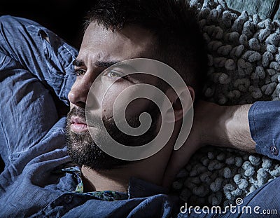 Portrait of young handsome serious man in a hammock. Stock Photo