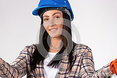 Portrait of young handywoman in a hard hat isolated on white. Gender stereotypes Stock Photo