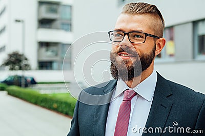Portrait of a young happy businessman outside the office buildin Stock Photo