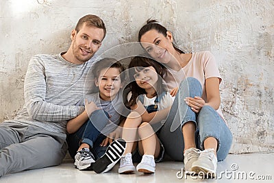 Portrait of young happy family with kids hugging Stock Photo