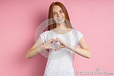 Portrait of young happy redhead woman in white t shirt Stock Photo