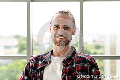 Portrait of young happy short stylish bearded caucasian man or creative designer smiling and looking at camera Stock Photo