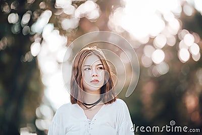 Portrait of young hipster Asian girl posing in the autumn park forest bokeh background Stock Photo