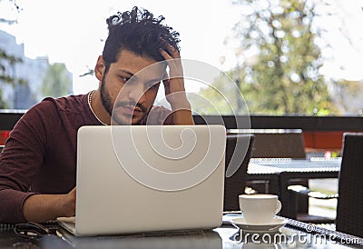 Portrait of young, hopeful Asian man in work. Young businesssman is working in a cafeteria. Business From coffee shop Stock Photo